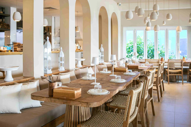 Modern dining space featuring eco-conscious furnishings in soft, neutral tones by Theodora Martinou, interior designer at Irregular Lines.