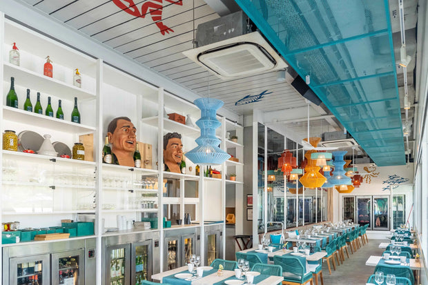 Dynamic and colorful restaurant interior with custom sustainable furniture designed by Theodora Martinou from Irregular Lines