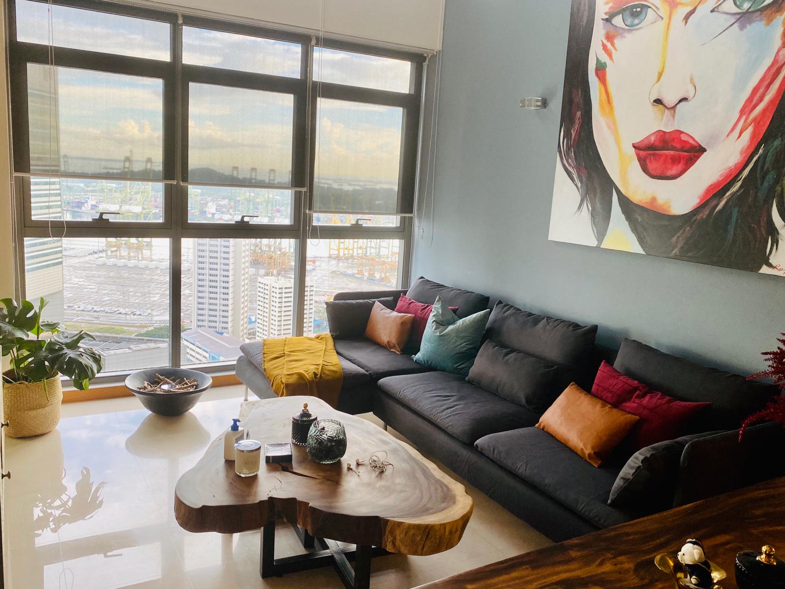 Contemporary Singapore living room featuring natural furniture and warm earthy interior styling.