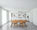 A white room with brown dining table and chairs